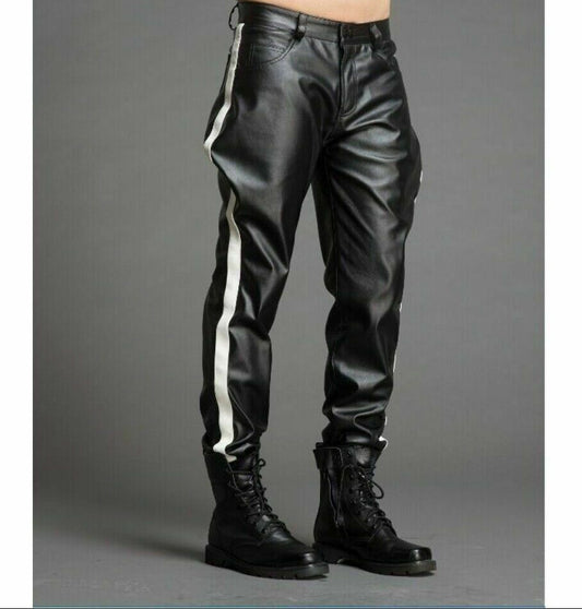 A person standing wearing black genuine leather trouser pants with white stripes on the legs, paired with black boots.